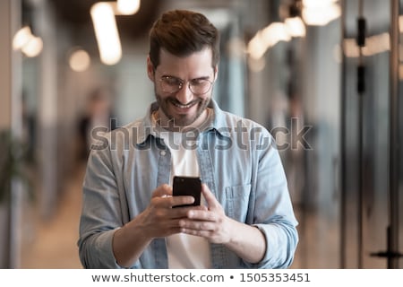 Stockfoto: Texting With Colleague On Smartphone