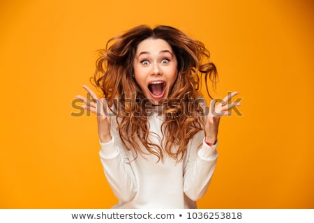 Foto stock: Portrait Of Excited Young Girl With Curly Hair