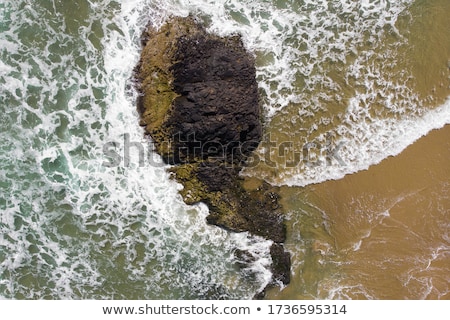 Сток-фото: Volcanic Rock And Sand Patterns In Water