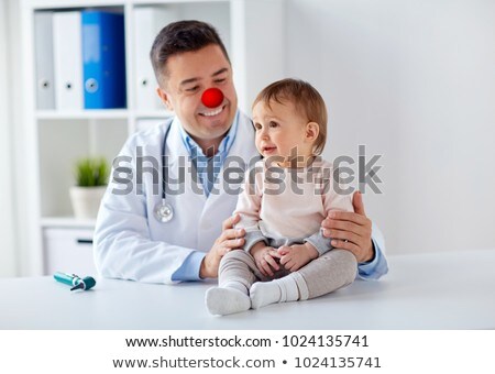 Stok fotoğraf: Happy Baby Girl At Doctor On Red Nose Day