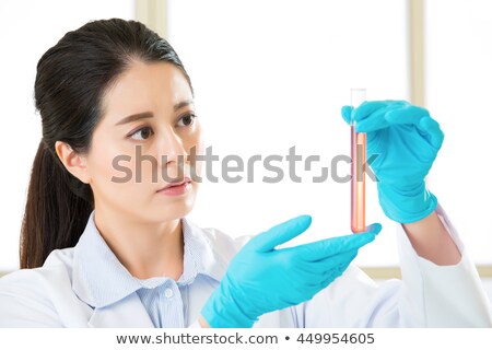 Zdjęcia stock: A Laboratory Medical Pathologist Pipetting A Sample