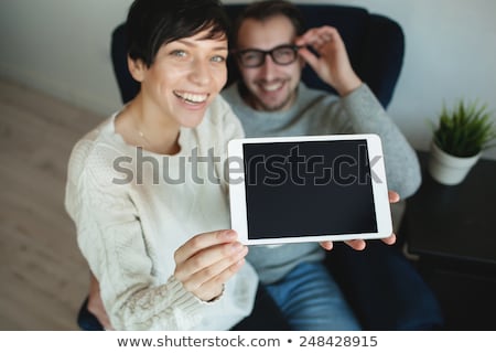 Stock photo: Casual Woman At Home Showing Digital Tablet Blank Screen For Copy Space Message Cheerful Female Hol