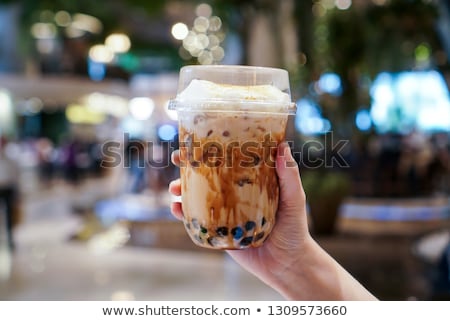 Stock photo: Man Drinking Cold Bubble Tea In Cafe