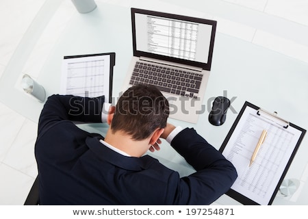 Foto d'archivio: Tired Businessman Sleeping While Calculating Expenses In Office