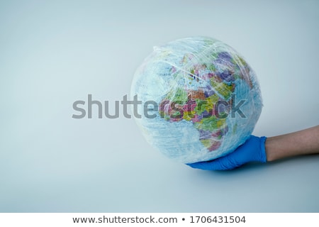 Stock photo: Doctor With A World Globe Wrapped In Plastic