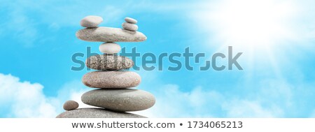 Stock photo: Pyramid Of Sea Pebbles Over A Sunny Sky