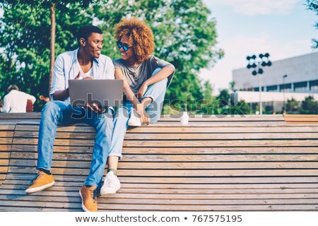 Foto stock: Two Students Using Laptop On Campus