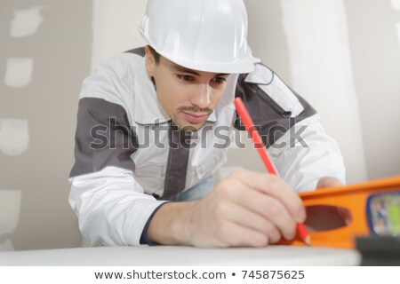 Foto stock: Making Sure Wall Is Straight