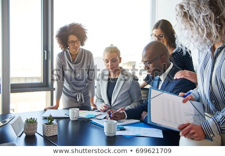 [[stock_photo]]: Businesspeople Reviewing Paperwork