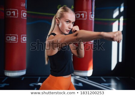 Сток-фото: Female Boxer Punching The Air