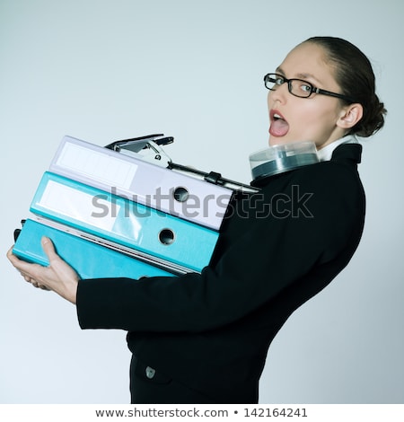 Stock photo: Studio Shot Portrait Of Businesswoman Carrying Heavy Files And Folders