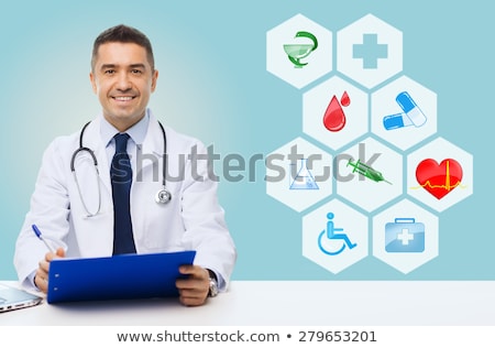 Foto stock: Smiling Doctor Over Medical Icons Blue Background