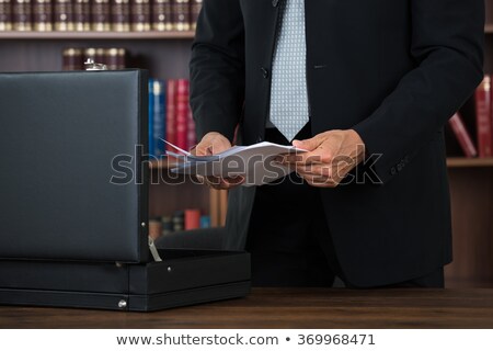 Stock fotó: Lawyer Keeping Documents In Briefcase In Office