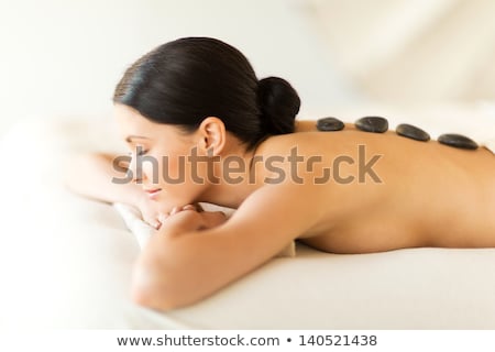 Stock photo: Beautiful Brunette Enjoying A Hot Stone Massage