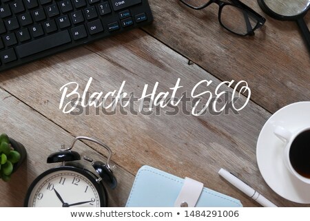 ストックフォト: Black Hat Seo On Laptop In Modern Workplace Background