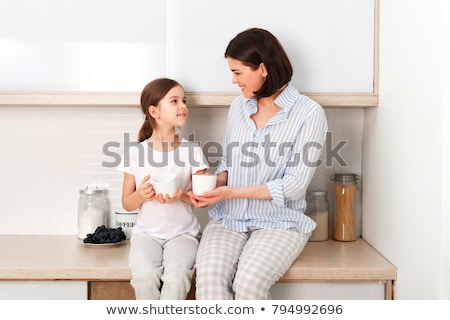 Zdjęcia stock: Mother And Daughter Preparing Cup Cake In Kitchen