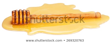 Stockfoto: Closeup Of A Honey Dipper In A Puddle Of Honey