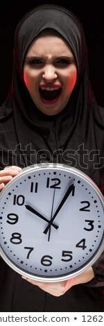 Сток-фото: Portrait Of Beautiful Serious Scared Frightened Young Muslim Woman Wearing Black Hijab Holding Clock