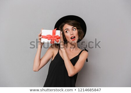 Сток-фото: Photo Of Beautiful Woman 20s Wearing Black Dress And Hat Holding