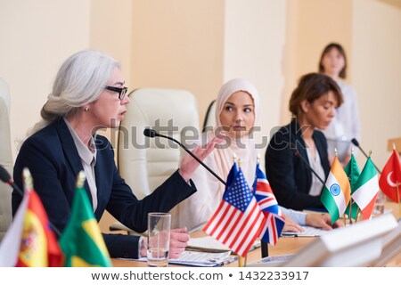 Foto d'archivio: Mature Confident Female Speaker In Elegant Suit Explaining Her Opinion