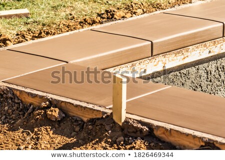 Stockfoto: Fresh Pool Coping Cement Drying Within Wood Framing