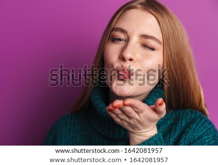 Stockfoto: Photo Of Pleased Young Woman Winking And Sending Air Kiss