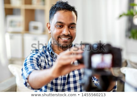 Stockfoto: Indian Male Video Blogger Adjusting Camera At Home