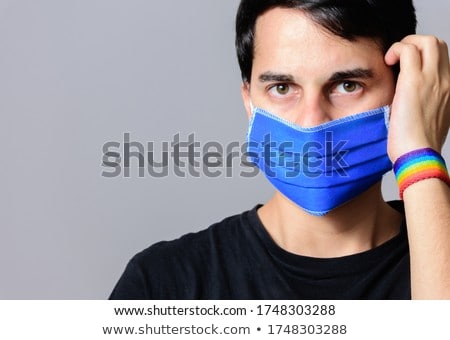 [[stock_photo]]: Man With Gay Pride Rainbow Flag And Wristband