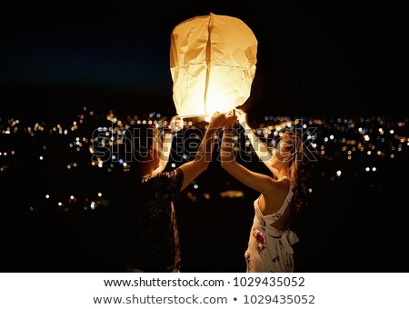 Stok fotoğraf: Happy Couple Launching Chinese Sky Lantern