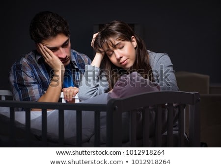 Foto stock: The Young Parents Sleepless With Newborn Baby At Night