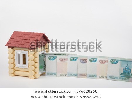 Stock photo: Before The Doors Open Toy House Lined Up Russian Rubles Banknotes Of Different Denomination