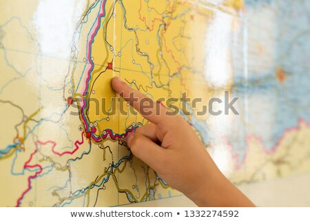 Foto d'archivio: Close Up Of Caucasian Boy Pointing His Finger On World Map In A Classroom At Elementary School