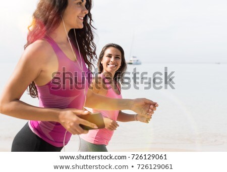 Stock photo: Two Girls Run A Race On The Beach Seaside