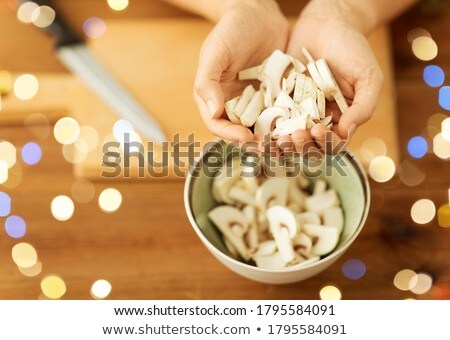 Foto stock: Close Up Of Woman Holding Chopped Champignons