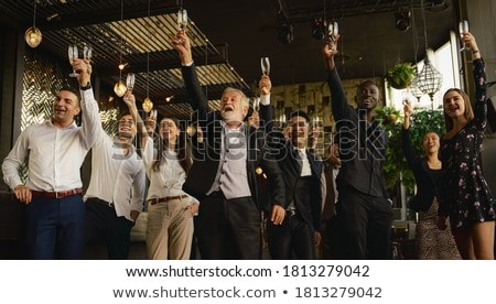 Foto d'archivio: Group Of Businesspeople Toasting Glasses Of Champagne