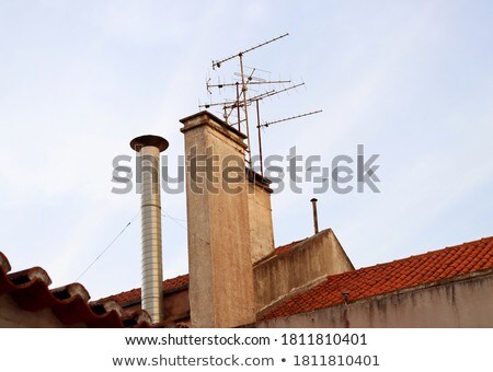 Stock photo: Set Of Old Ventilation Chimneys Against Blue Sky