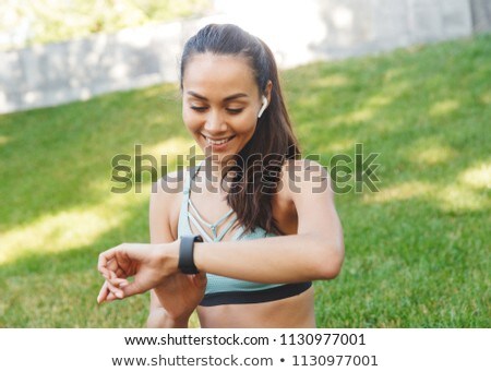 Stok fotoğraf: Photo Of Smiling Caucasian Woman Using Wireless Earphone