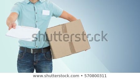 ストックフォト: Mid Section Of Delivery Man With Box And Clipboard