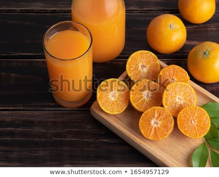 Stok fotoğraf: Glassware Of Fresh Orange Juice Ripe Fruit And Wooden Squeezer Against White Background Slice Of O