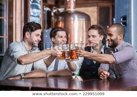 Foto d'archivio: Men Clinking Their Glasses At Table