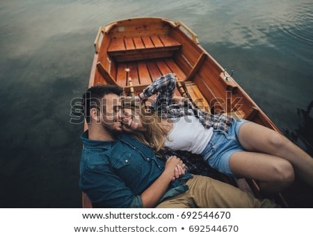 Foto stock: Loving Couple Rowing On The Lake