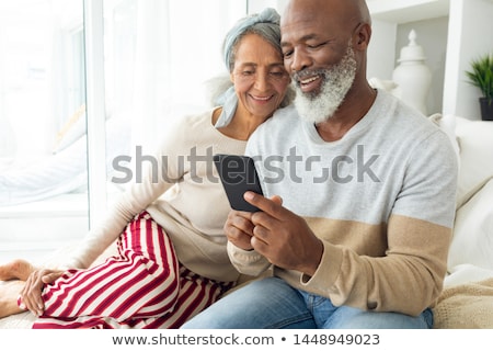 Stockfoto: Front View Of Active Senior Couple Using Digital Tablet In Living Room At Home