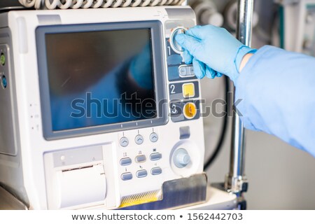 Stockfoto: Paramedic In Gloves Adjusting Medical First Aid Equipment Inside Ambulance Car