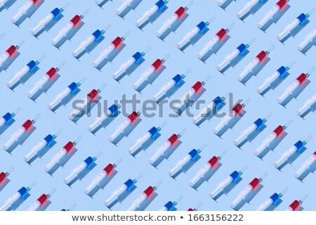 Stock foto: Health Care Pattern Of Disposable Syringes With Blue Liquid