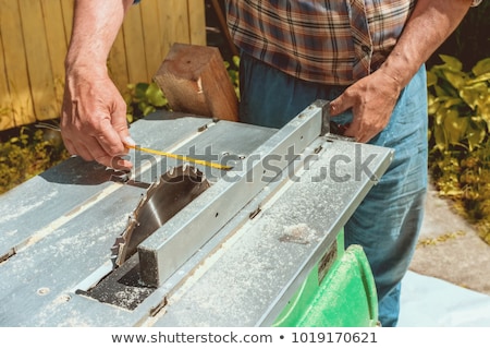 Stock photo: The Worker Makes Measurements Of A Wooden Board
