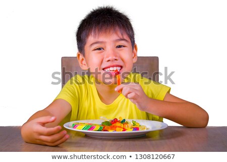 Foto stock: Little Boy Eating Candies