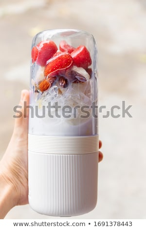 Imagine de stoc: Woman Holding Electric Blender