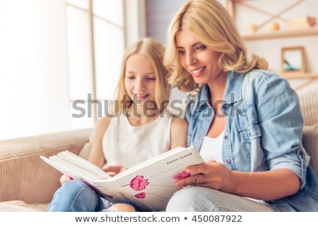 Stock fotó: Two Women Looking Through Photo Album