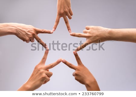 Foto d'archivio: Hands Of Teamwork Forming The Star Shape
