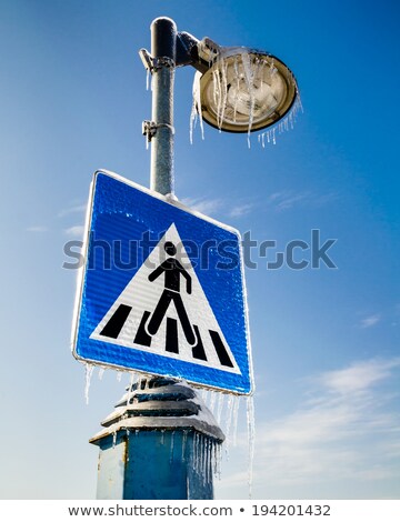 ストックフォト: Frozen Road Sign For Pedestrians With The Street Lamp Above